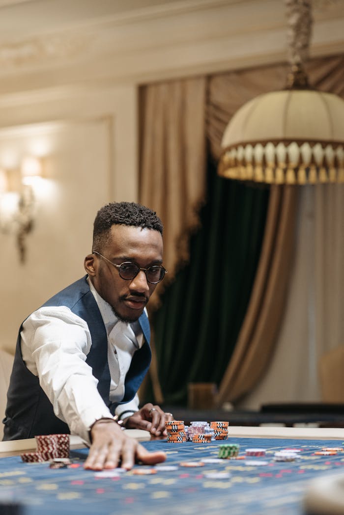 A man placing his bet at a luxurious casino roulette table.